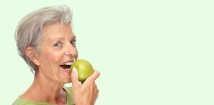 Lady Eating Apple with Digital Dentures