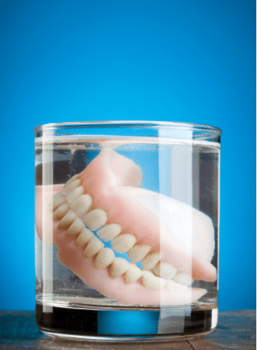 Dentures In Glass 2 - Changing Smiles Denture & Implant Center